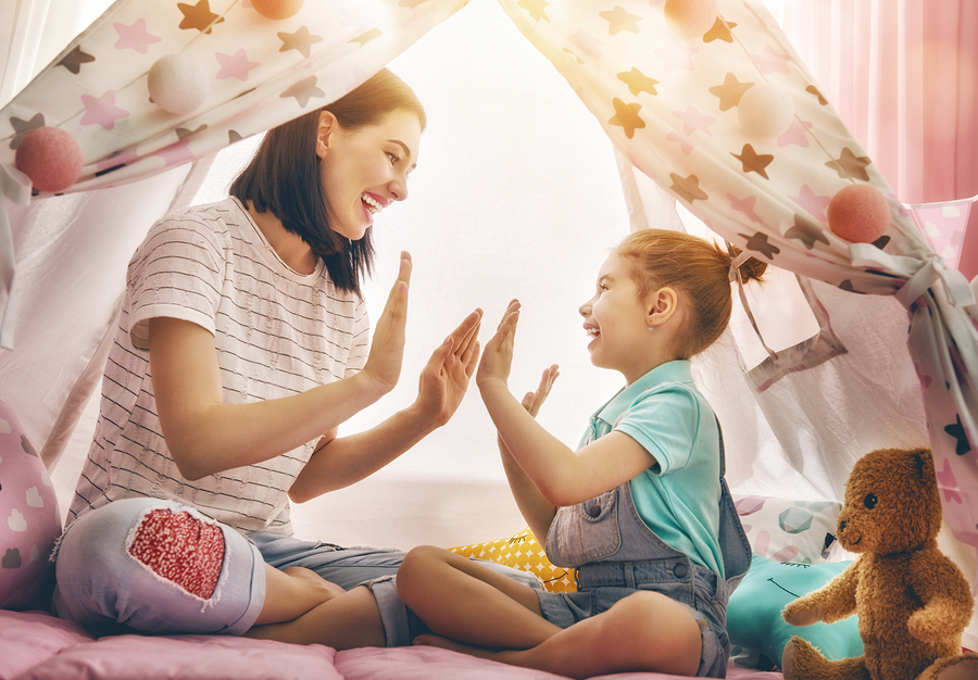 Parent and child playing a high-five game
